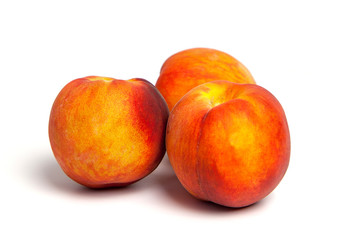 Fototapeta na wymiarThree peaches on a white background 