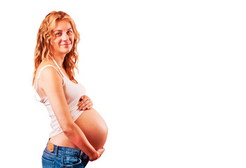 Pregnant woman holding her hands on her belly isolated on white with clipping path