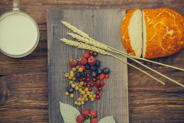 bread wild berries and cup of milk