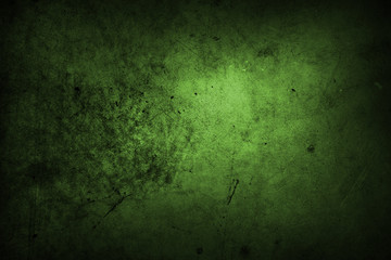 Green grunge concrete stone wall background. Dark edges