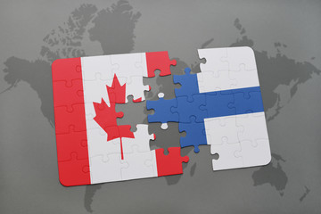 puzzle with the national flag of canada and finland on a world map background.