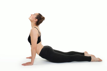 Young brunette woman doing pilates exercises isolated