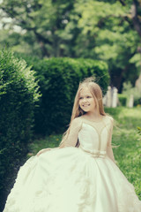 Fototapeta premium small girl in white dress outdoor