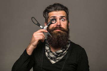 bearded man with hairdresser scissors