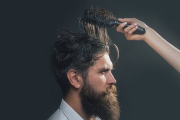 female hand combing bearded man