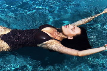View from the top. Portrait of a beautiful sexy woman swimming in the pool