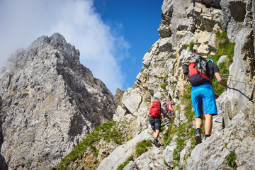 mountaineering men / climbing in the alps of Austria at Wilder Kaiser