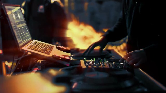 cool dj behind the turntables performing