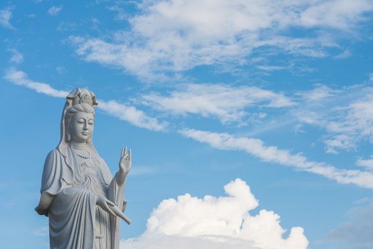 The beautiful statue of Guanyin with blue sky and copy space. - Chinese goddess statue (a public temple , can take picture )