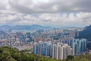 View of Hong Kong during the day - Hong Kong buildings and Victoria Harbor with blue sky clouds
