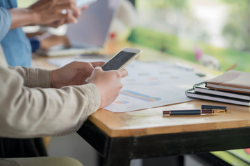 Young businesswoman hard at work at her desk writing notes on a