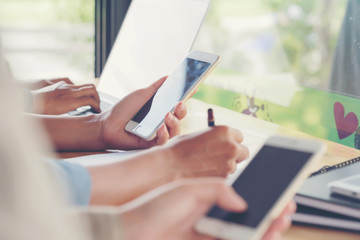 Young businesswoman hard at work at her desk writing notes on a