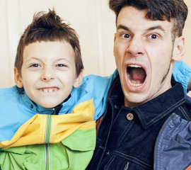 young handsome father with his son fooling around at home, lifestyle people concept