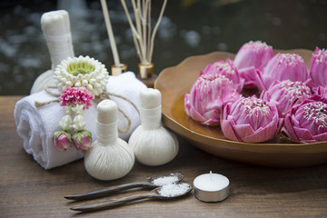 Fototapeta na wymiar Spa massage compress balls, herbal ball with treaments spa and lotus , Thailand, soft focus 