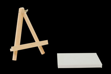 Blank canvas and easel for painting, Isolated image. Black backg