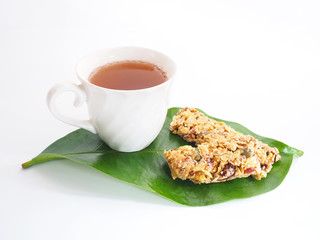 White cup of tea and healthy granola
