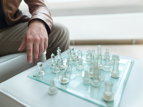 A man playing chess and thinking about a suitable strategy.