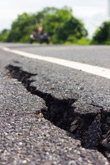 Cracked asphalt road close-groove.