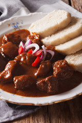 Czech Food: Traditional goulash with dumplings macro. vertical
