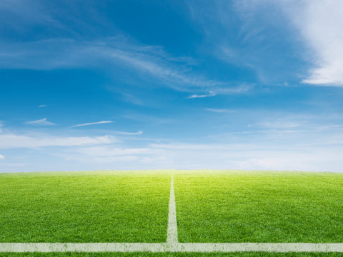 empty soccer field with blue sky background