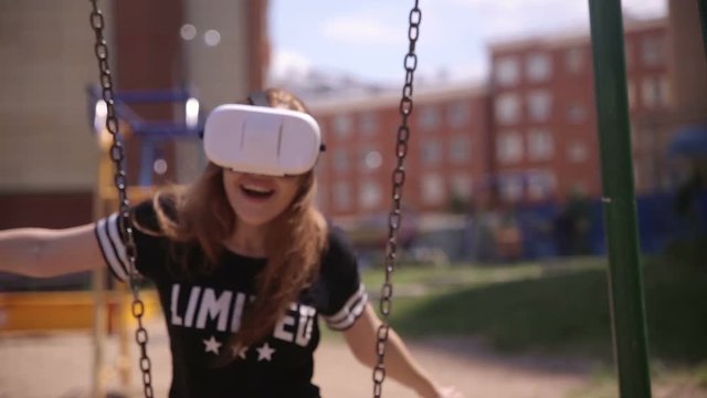 Young woman enjoying VR-attraction. Getting excited with realistic graphic and feelings provided by vr-headset. HD.