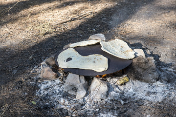 Pita bread on a tabun outdoors