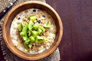 Homemade granola with milk and kiwi