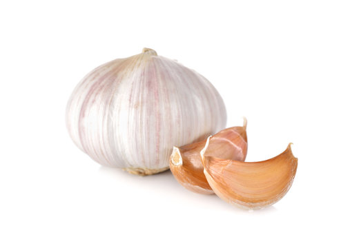 uncooked whole garlic with shell on white background