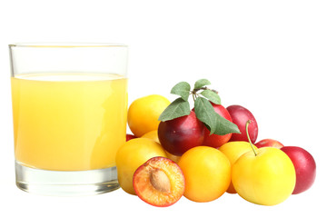 plum with a glass of fresh juice on white isolated background