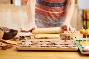 Close-up image of woman making Halloween cookies at home