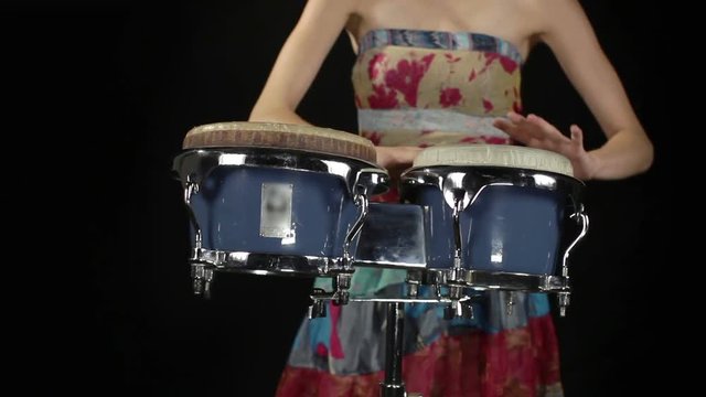 female percussion drummer performing with bongos