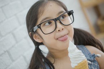 Happy Asian girl enjoy eating soft ice-cream