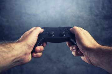 Man using gamepad controller to play video games © Bits and Splits