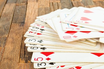 Playing cards on wooden background. Macro shot.