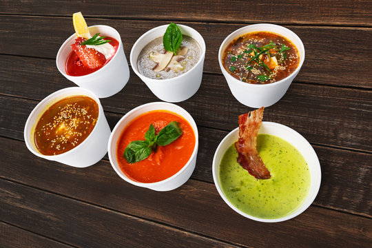 Variety of soups from different cuisines at brown wood