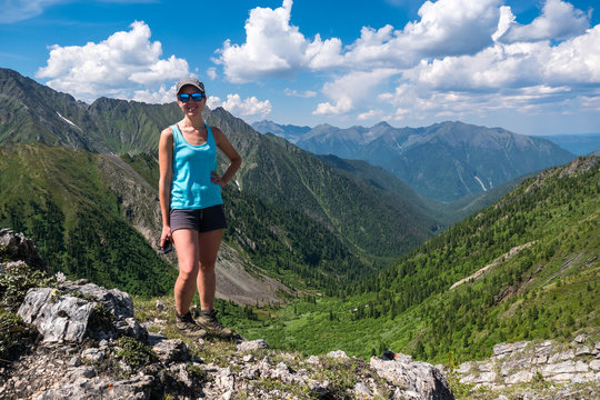 girl standing at the top of the pass Arshansky in Tunka range