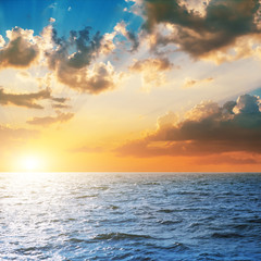 Fototapeta premium bright sunset over blue sea