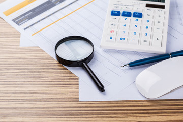 work with a magnifying glass, a calculator and papers