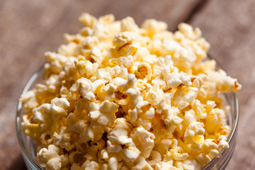Salt popcorn on the wooden table