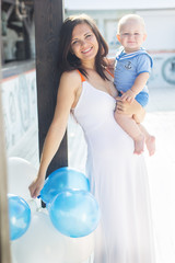 Pretty mom and son with balloons