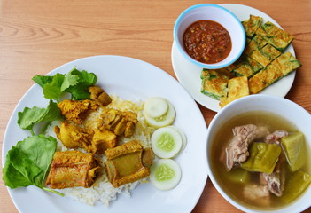 pork rib in yellow curry on rice with fried egg and soup