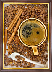 cup of coffee, coffee beans, anise and cinnamon close-up