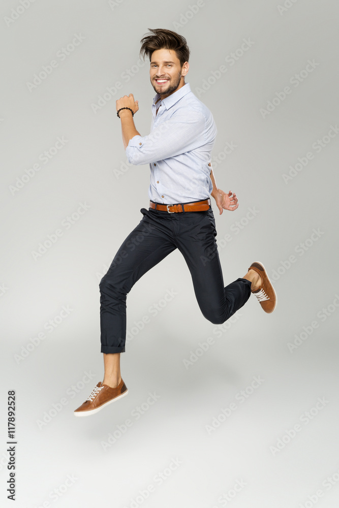 Wall mural Handsome man jumping