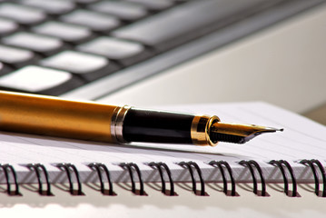 image of pen on keyboard background closeup