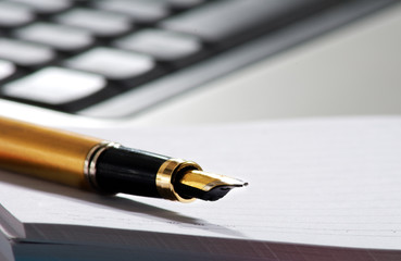 image of pen on keyboard background closeup