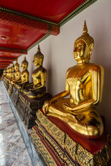 Row of golden  Buddhas  at  Wat Pho in Bangkok Thailand.