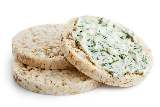 Pile of three puffed rice cakes isolated on white. With chive and herb spread.