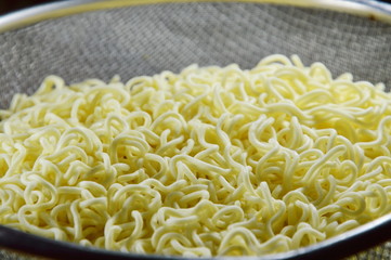 boiled instant noodle on stainless sieve