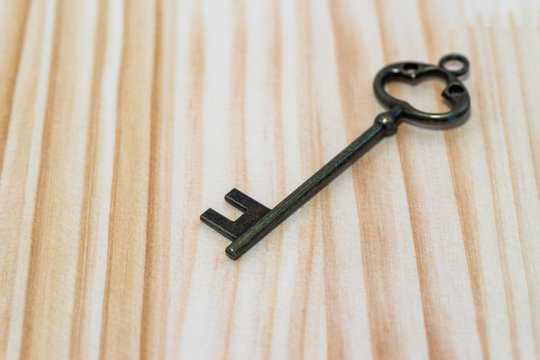 Key on wooden background