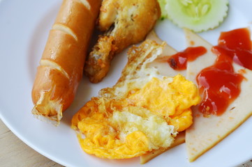 deep fried egg and sausage dressing tomato sauce on plate